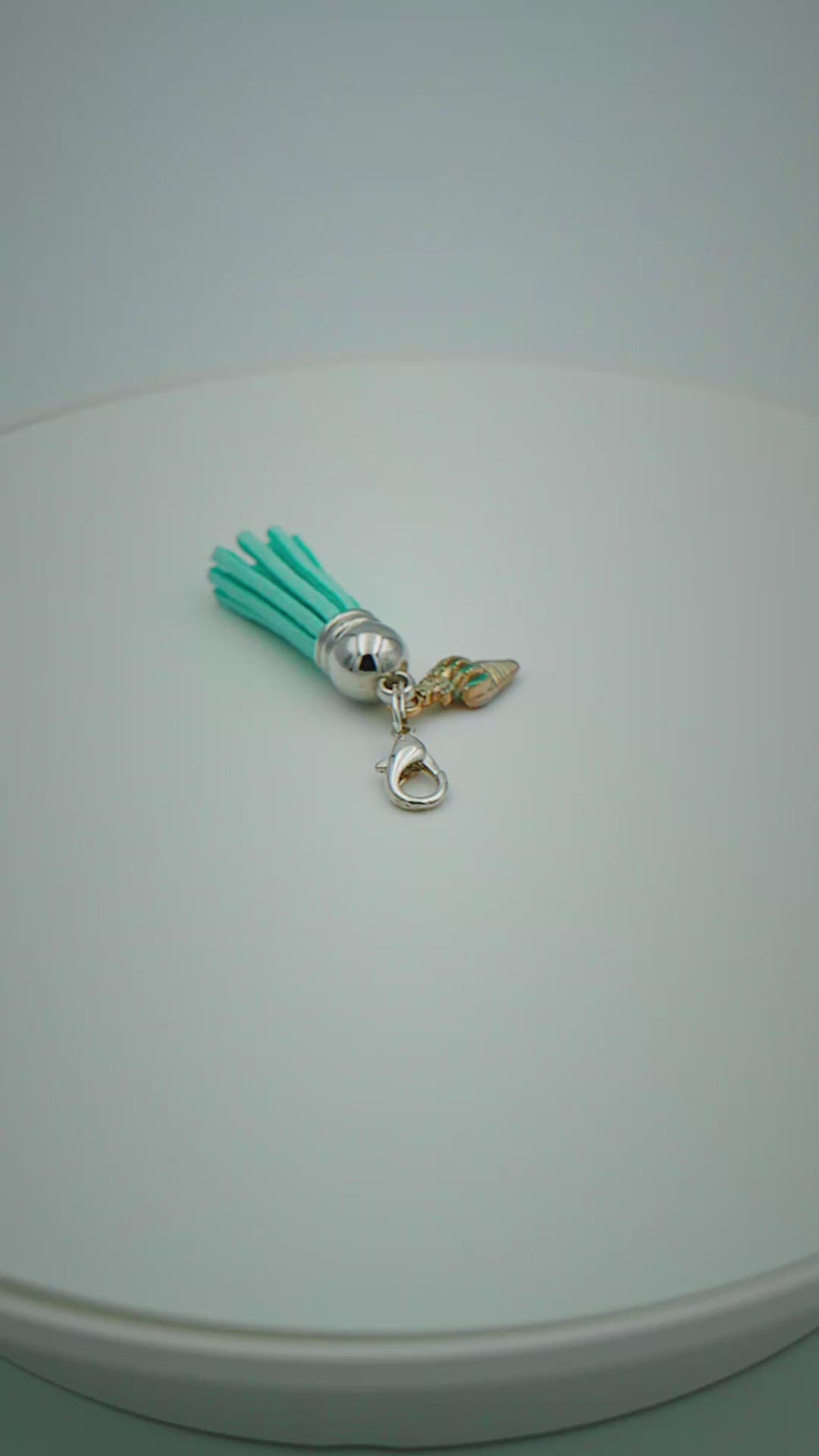 Load video: Turquoise Suede Tassel Bag Charm with Seashell